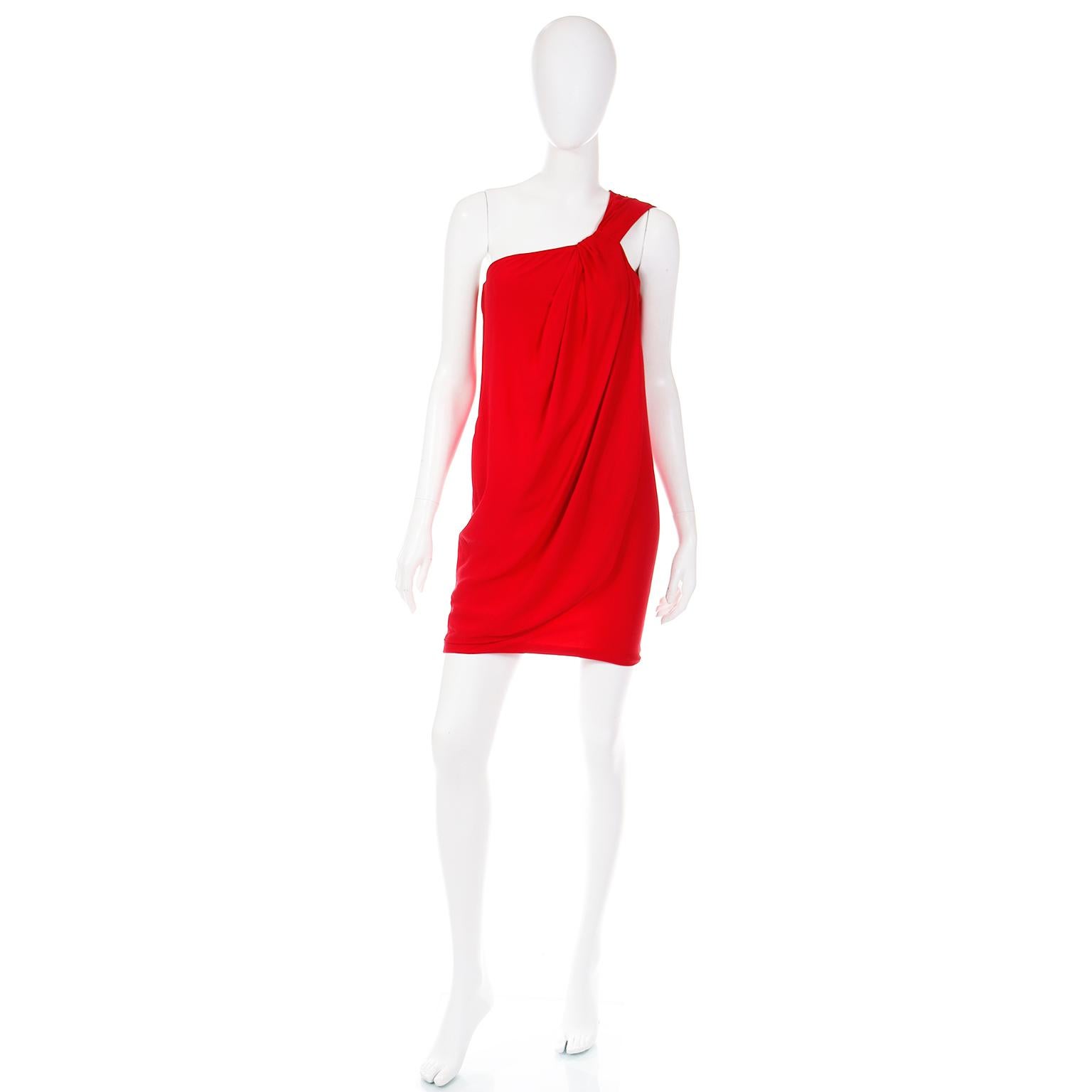 This luxe red silk vintage dress was designed by Emanuel Ungaro in the 1990's. This Ungaro Parallele evening dress is in a rich blue toned red which is the most flattering shade!  The fine silk chiffon gives the dress have a lot of movement and we