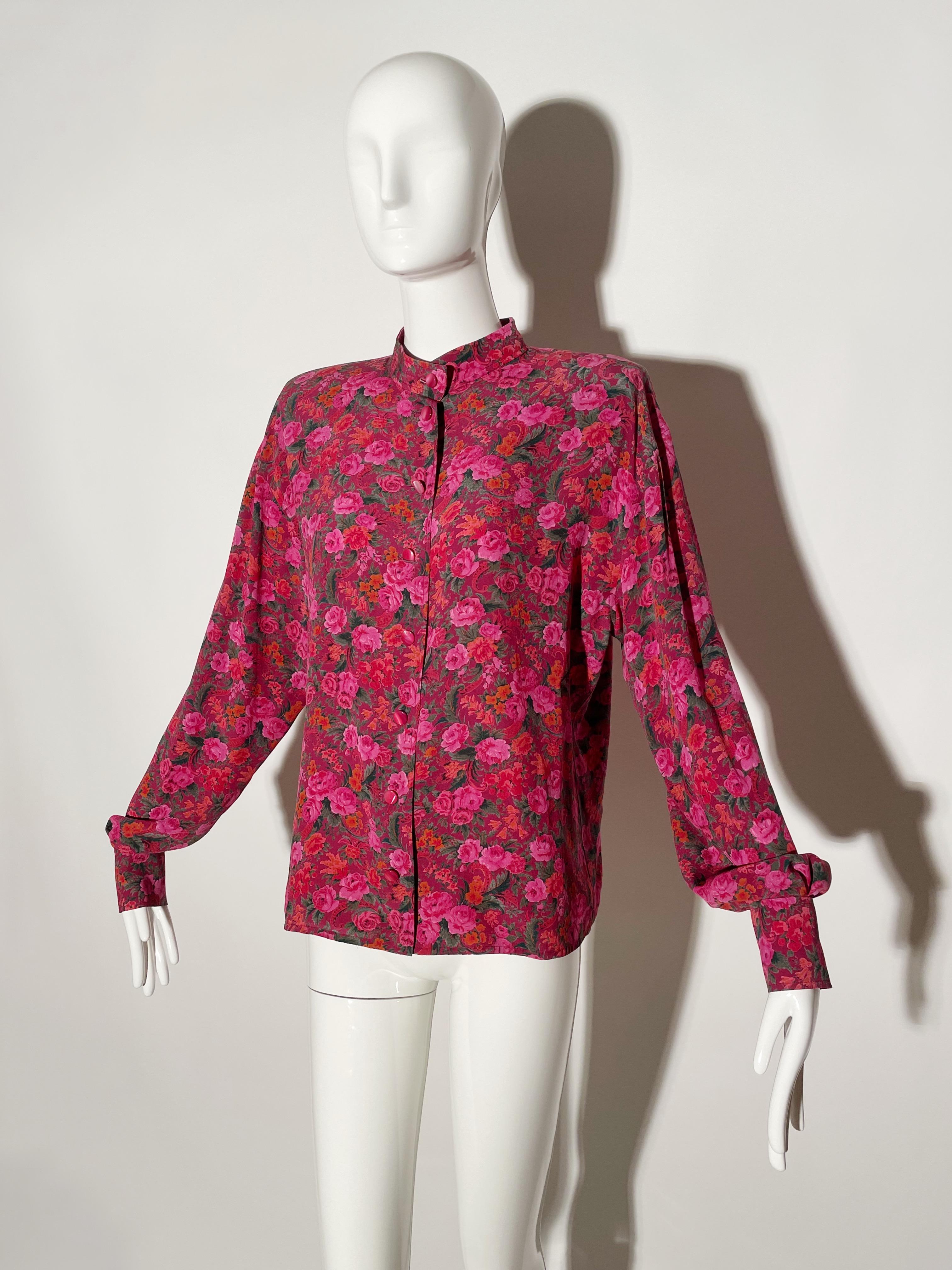 Pink floral blouse. Front button closures. Shoulder Pads. Collarless. Silk. Made in Italy.

*Condition:  excellent vintage condition. No visible flaws.

Measurements Taken Laying Flat (inches)—

Shoulder to Shoulder: 20 in.

Bust: 40 in.

Sleeve