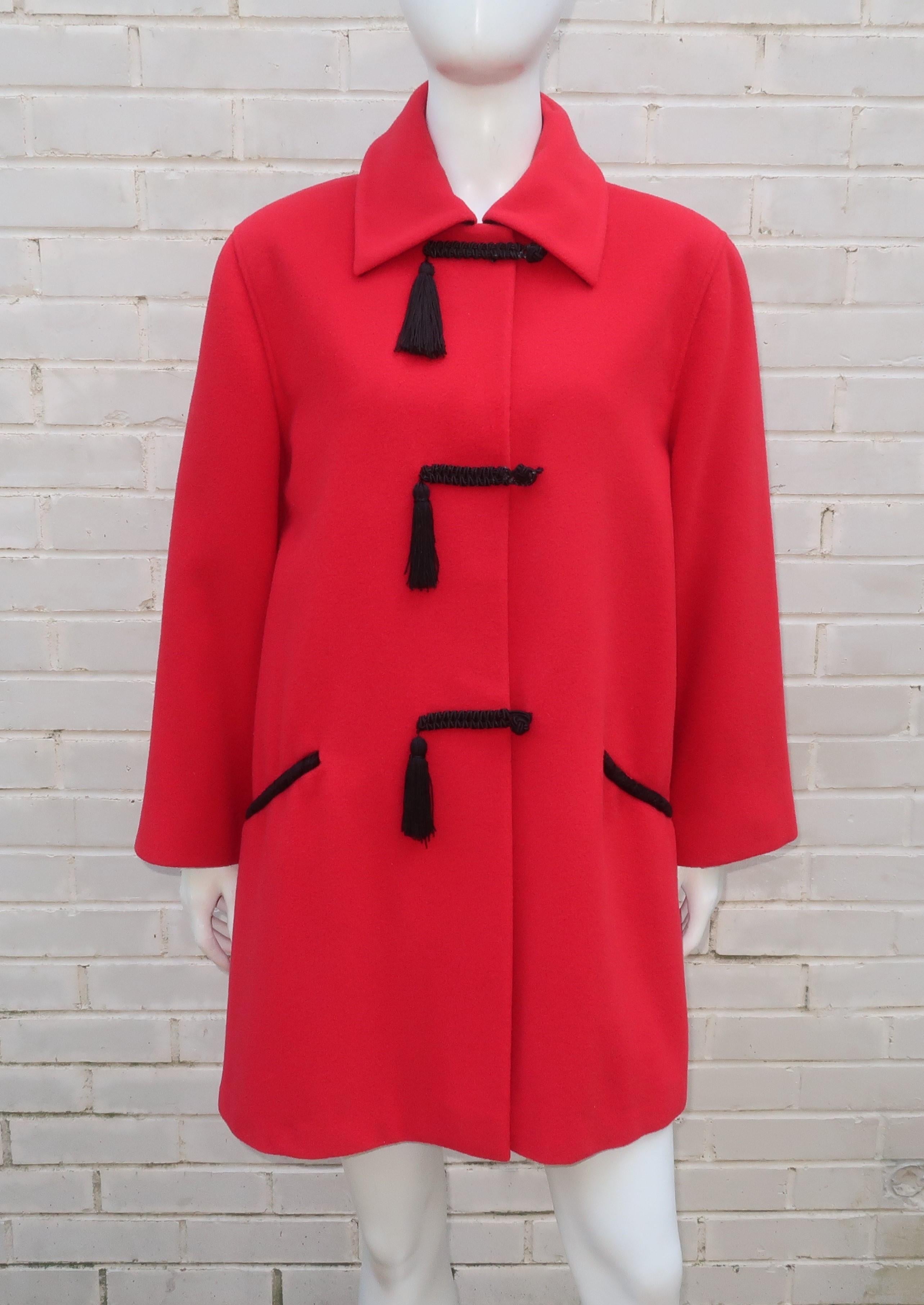 1980's Ungaro red wool car coat with black satin lining and frog style closures with tassel accents.  The coat snaps at the collar and has faux side pockets.  It is a nice boxy shape that can be worn over everything from evening wear to