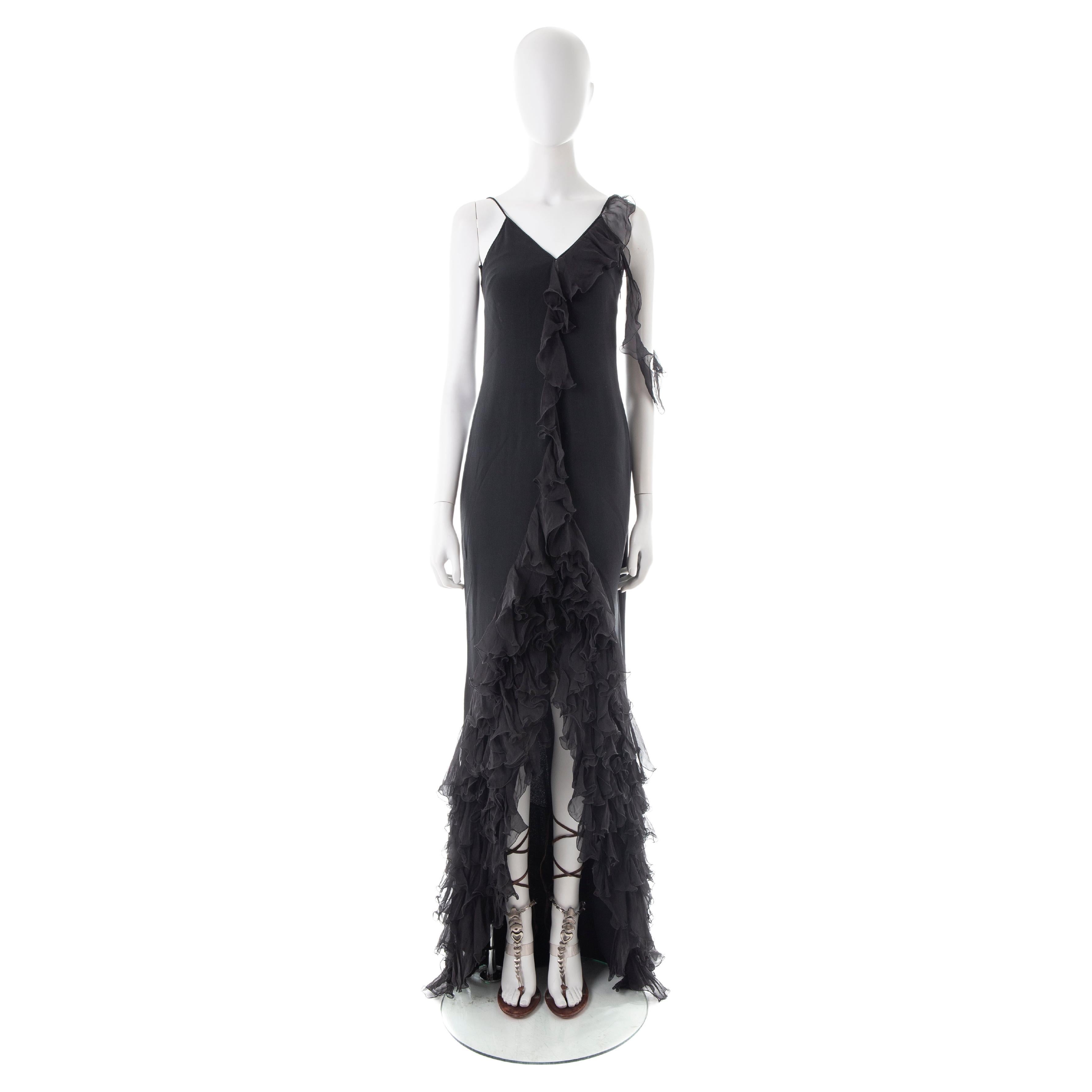 - Emanuel Ungaro by Giambattista Valli
- Black silk trained evening dress
- Spaghetti straps, ruffled on one side
- Mini front cut-out keyhole 
- High low ruffled skirt
- Size IT 40

(shoes sold separately)