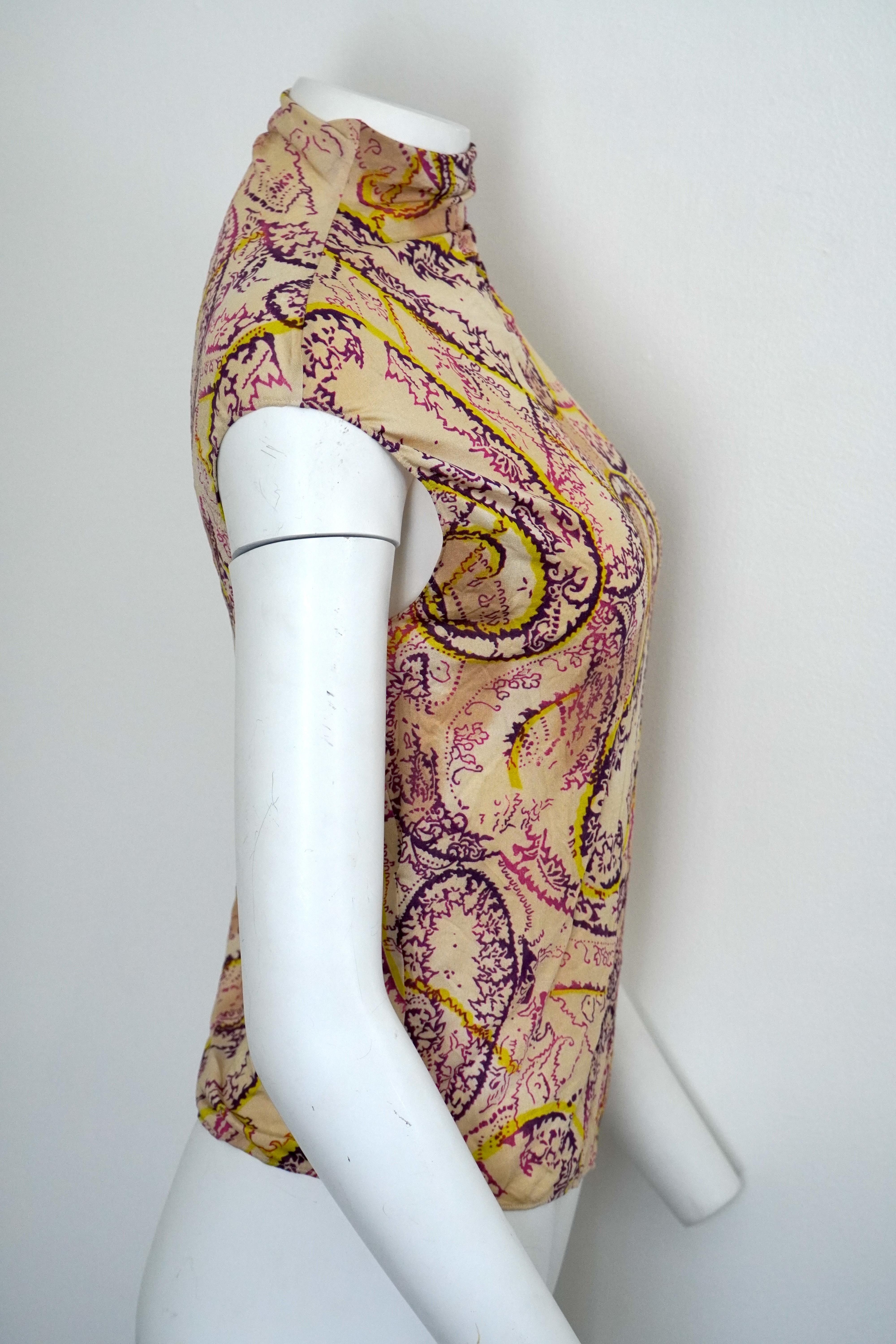 Emanuel Ungaro Sleeveless Mock Neck Paisley Top 
sz 38
Fabric has great stretch
Pink, purple, yellow, and cream paisley print
93% Rayon
7% Spandex
Dry clean only

Emanuel Ungaro was a French fashion designer of Italian descent, renowned for his bold