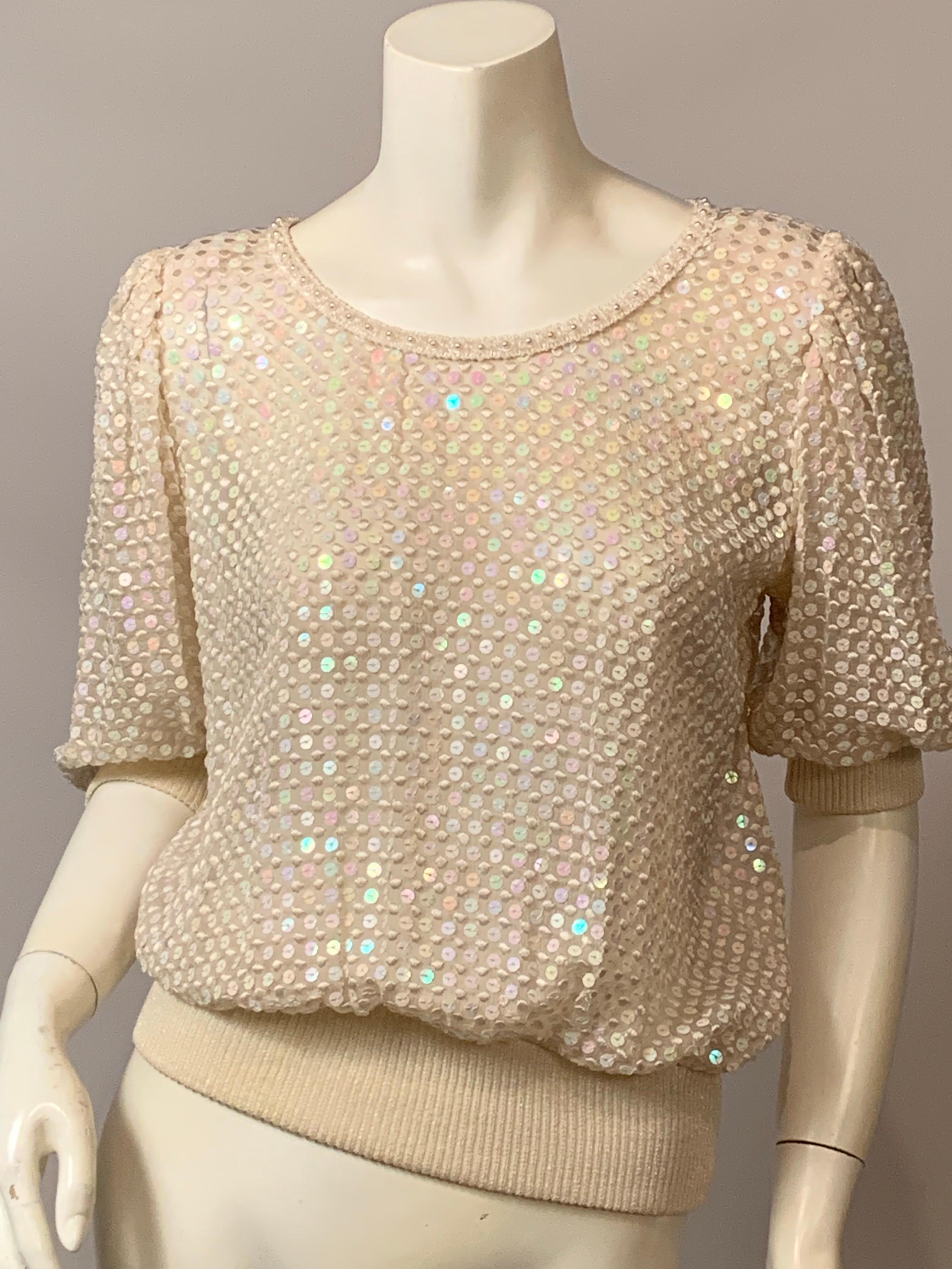 This Emanuel Ungaro sheer silk chiffon top has it all!  The neckline is trimmed with a pearl studded braid, the sheer silk chiffon is embellished with a combination of embroidered silk dots and flat iridescent sequins glistening across the front,