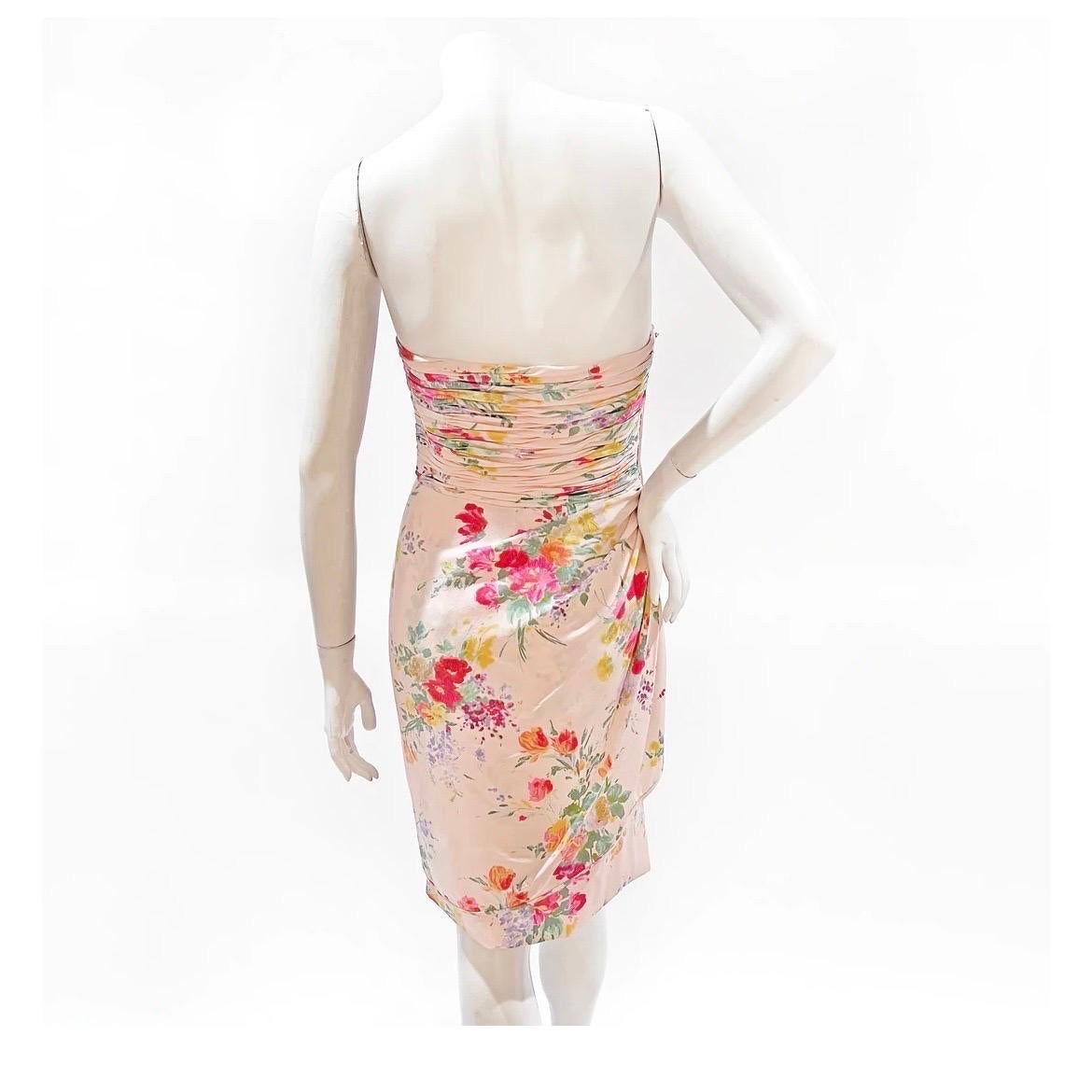 Vintage pink floral strapless dress by Emanuel Ungaro 
Circa 1980's- early 1990's
Made in Italy 
100% silk 
Synthetic lining
Strapless 
Pale pink with multicolor floral print 
Ruched to waist 
Back zip closure
Drape detail on right hip
Excellent