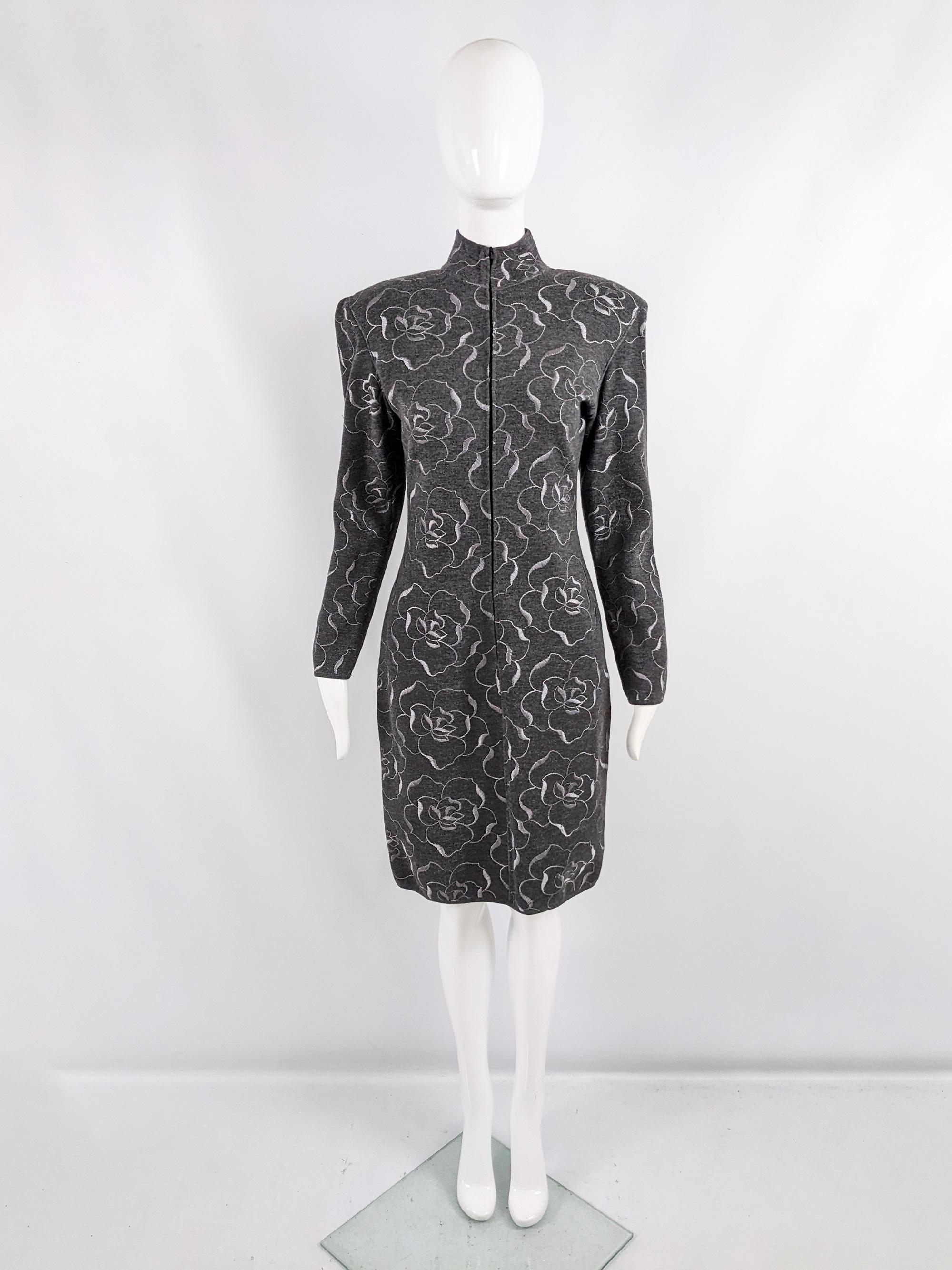 A stunning vintage womens dress from the 80s by luxury French fashion designer, Emanuel Ungaro. Made in Italy from a grey wool knit fabric highlighted with intricate lighter grey embroidery throughout. The silhouette is sexy and bold, with the knit