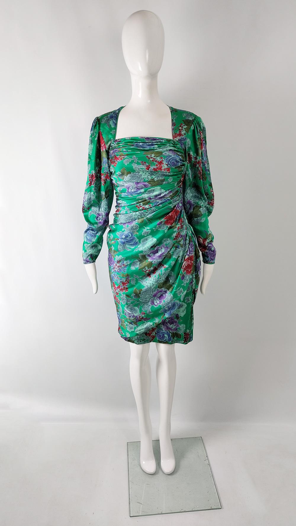 An ultra glamorous vintage womens evening dress from the 80s by luxury French fashion designer, Emanuel Ungaro. Made in Italy, from a green silk satin with one of Ungaro's bold Asian inspired floral prints throughout. Emanuel Ungaro is one of the