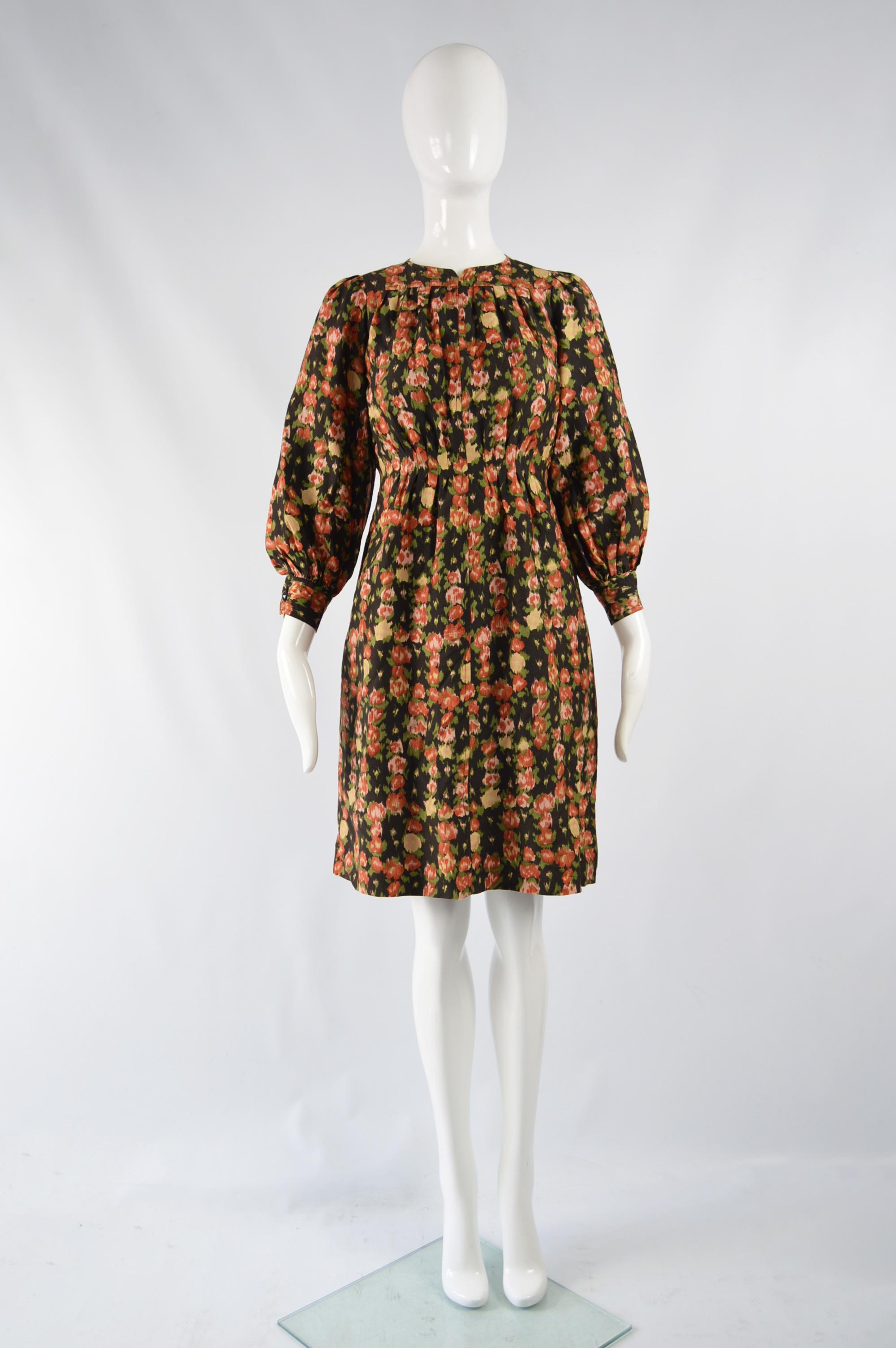 A beautiful vintage womens dress from the 70s by luxury French fashion designer, Emanuel Ungaro. In a black floral printed fabric with large puff sleeves and a pleated skirt. Great for day or evening. 

Size: Unlabelled; fits like a UK 10/ US 6/ EU
