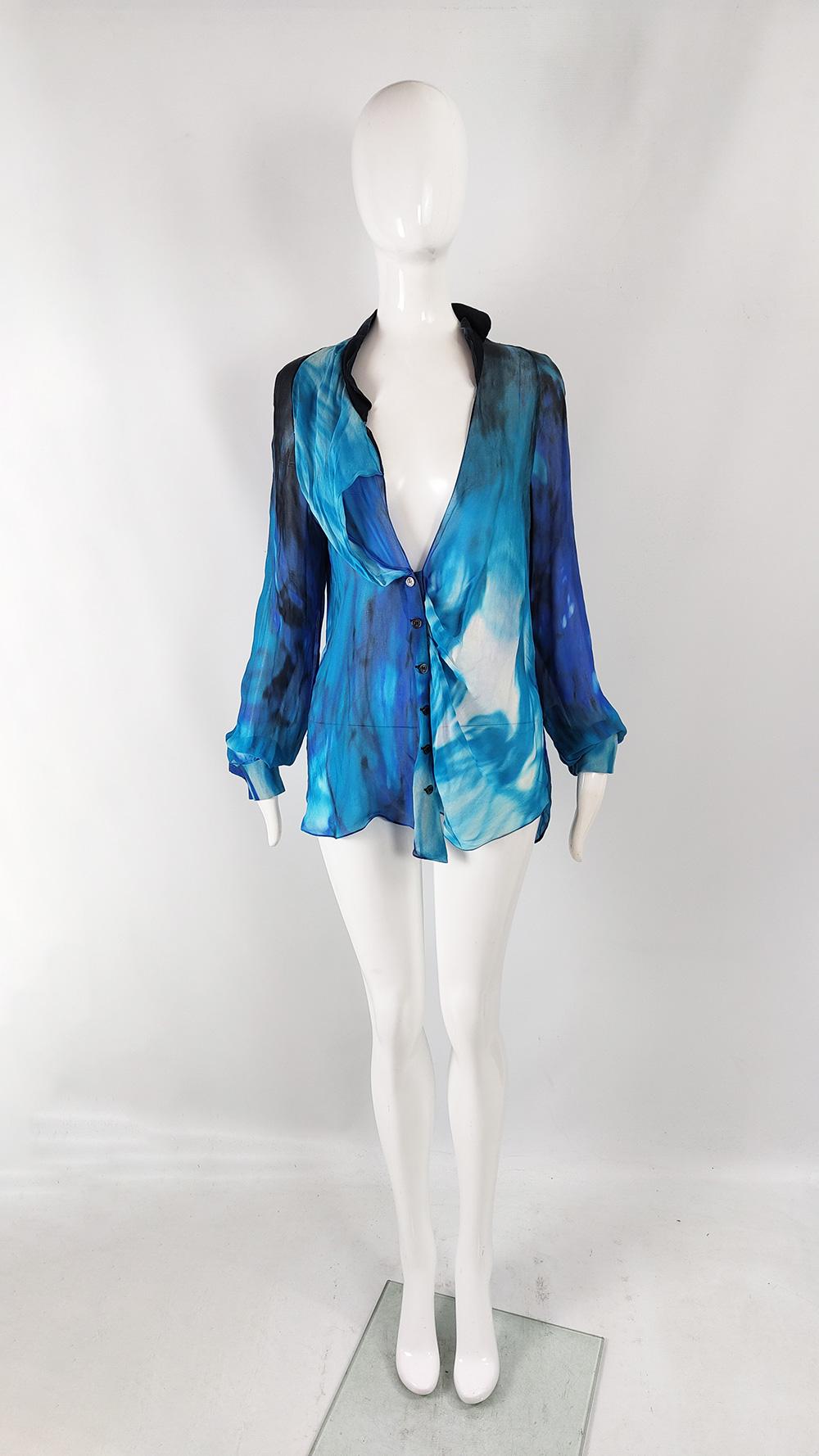 A stunning vintage womens blouse from the 2000s by luxury Parisian fashion house, Emanuel Ungaro. In a sheer blue, black and white abstract printed pure silk chiffon that gives incredible movement, and conjures up images of the sea. It has a loose,