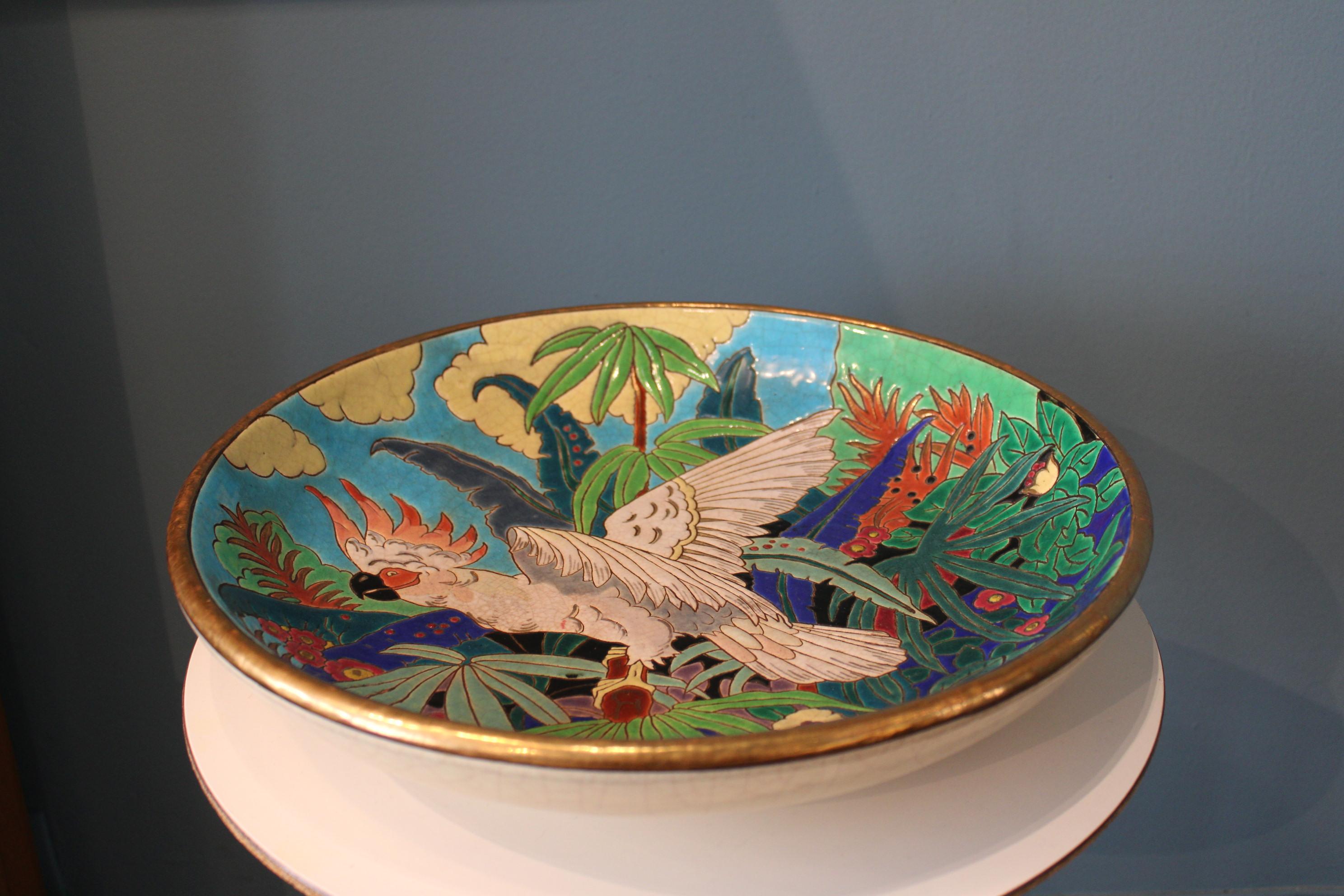 Ceramic dish with parrot, from the French Manufacturer of Emaux of Longwy 
France, 20th century.