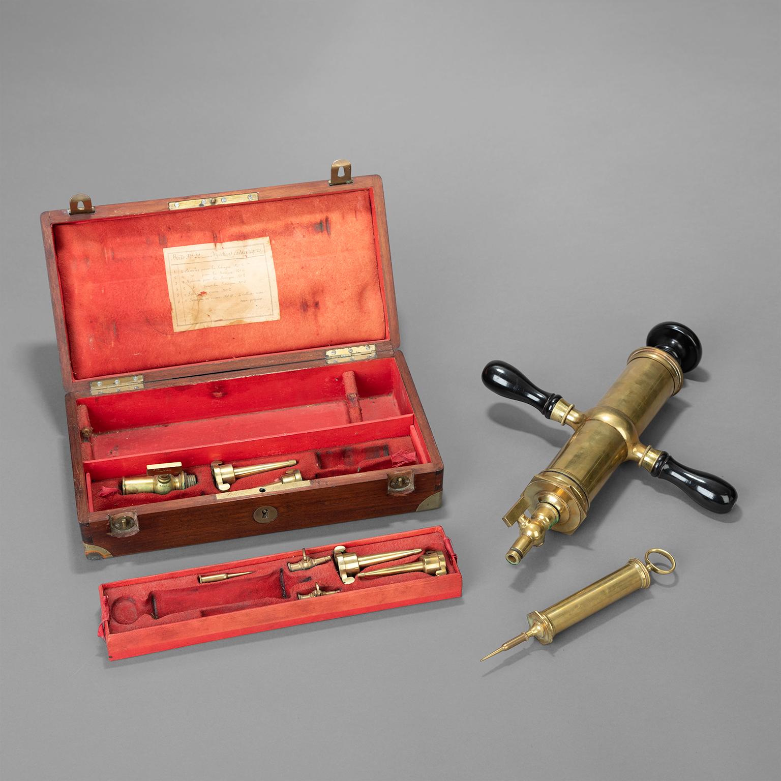 Thanatopraxis set for the preservation of bodies after death. Complete with lacquered brass syringes, tips and accessories, presented in a varnished mahogany case. Marked: 