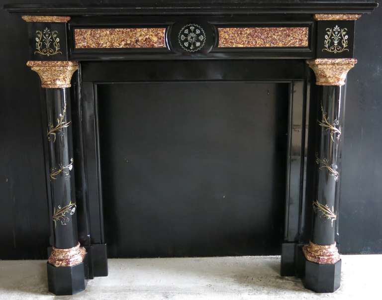 Rare embassy-quality fireplace hand-carved in black marble from France, early 1800s.
Flowers graved with gold leaf and old paint from that period.
Exquisite quality of work.

Firebox measures: width 81cm x high 87.5cm
High of the column 84.5cm

More
