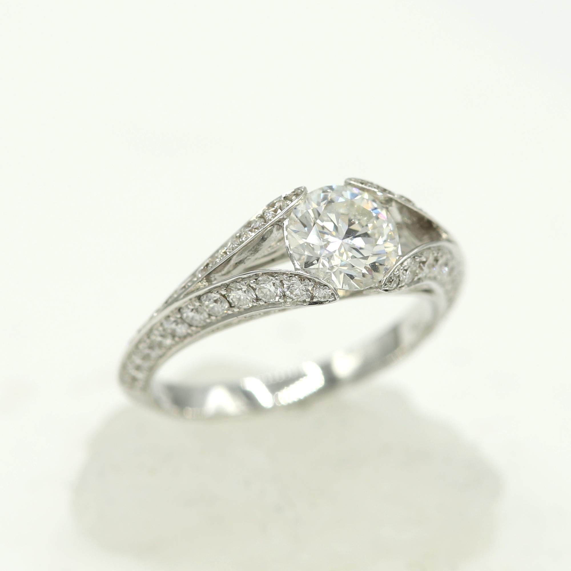 Diamond Ring with a unique bridge setting - the diamond is embedded in the ring design rather then sticking out.
18k white gold 3.70 grams.
Center Diamond size 1.04 carat J-VS1 GIA certificate
round shape. plus small diamonds 0.84 carat.
Finger size