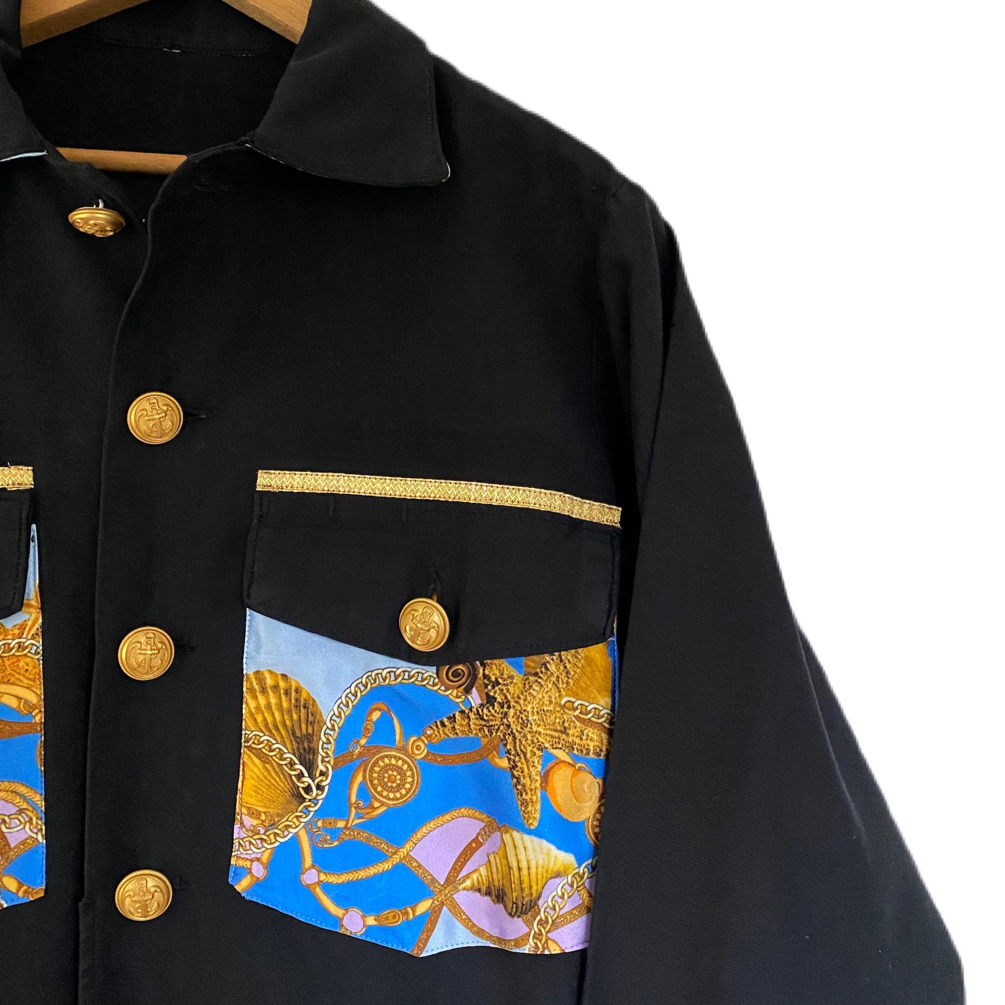 Embellished Black Us Fatigue Shirt Jacket Repurposed with Designer Light Blue Printed Silk and Vintage Collectible Military Vintage Gold Tone Buttons in Brass.

100% Sustainable Created with Vintage and Deadstock.
Brand: J Dauphin

Size: