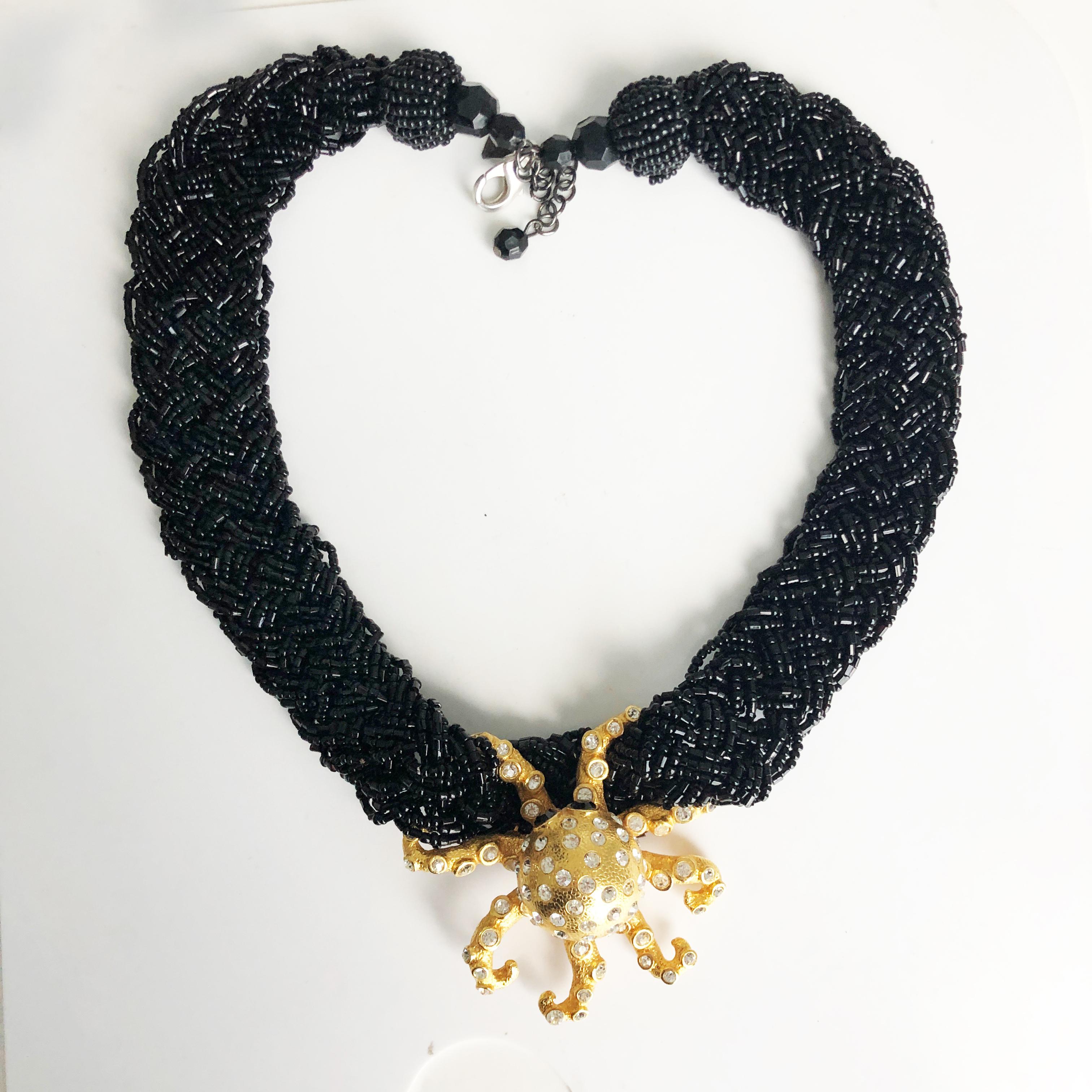 This one-of-a-kind piece was created by Stephanie Lake Design in 2013.  It features an antique, rhinestone-encrusted golden octopus set on a thick black jet bead braided chain.  

One of a kind, this is a spectacular piece, guaranteed to generate