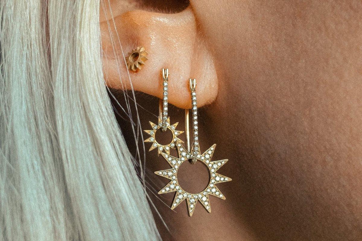 The Pavé Mini Spur Earring – designed and handmade by EMBLM Fine Jewelry

The twelve point star shape of the Pavé Mini Spur Earring Charm moves freely within the handmade oblong hoop of the Pavé Half Latch Earring. The two pieces can also be worn
