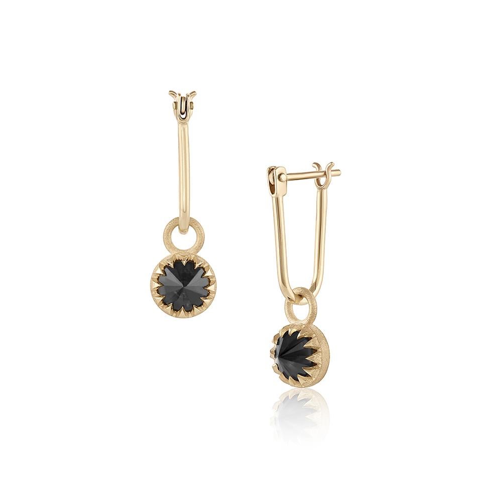 The Peristome Inverted Diamond Earring – designed and handmade by EMBLM Fine Jewelry

Inspired by our signature twelve point star design, the triangular prongs enclose around a black diamond, reminiscent of a peristome — the fringe found around the
