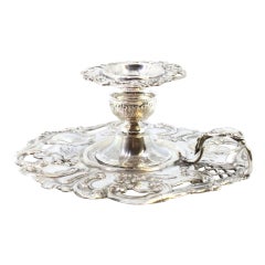 Embossed and cut silver paddle, with a monogrammed card on the handle