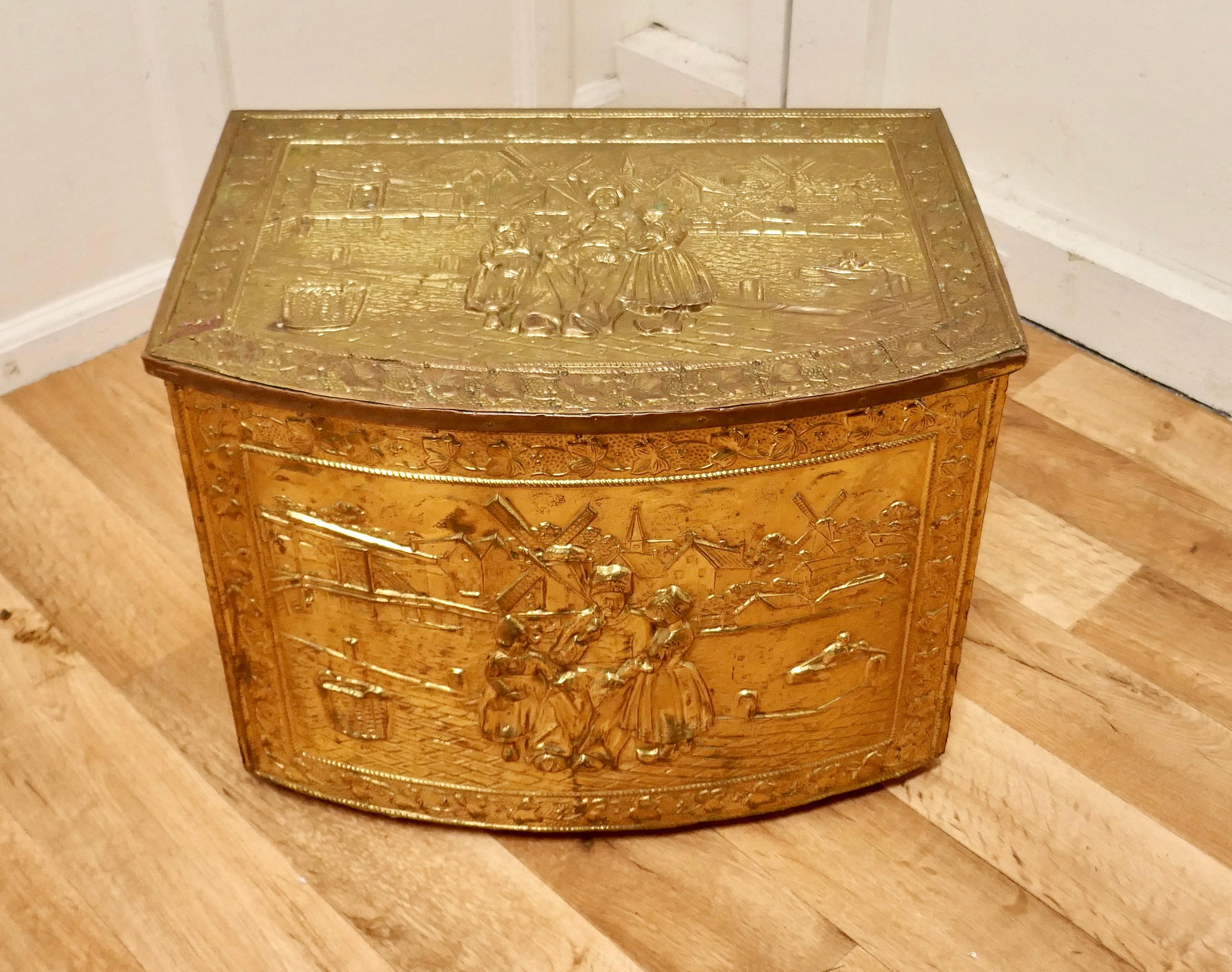 Embossed Arts and Crafts brass log or coal box with dutch scenes 


This is a lovely chest is made in Brass with a wooden lining, the beaten brass is embossed with country scenes showing windmills and characters in Dutch costume
This is an old