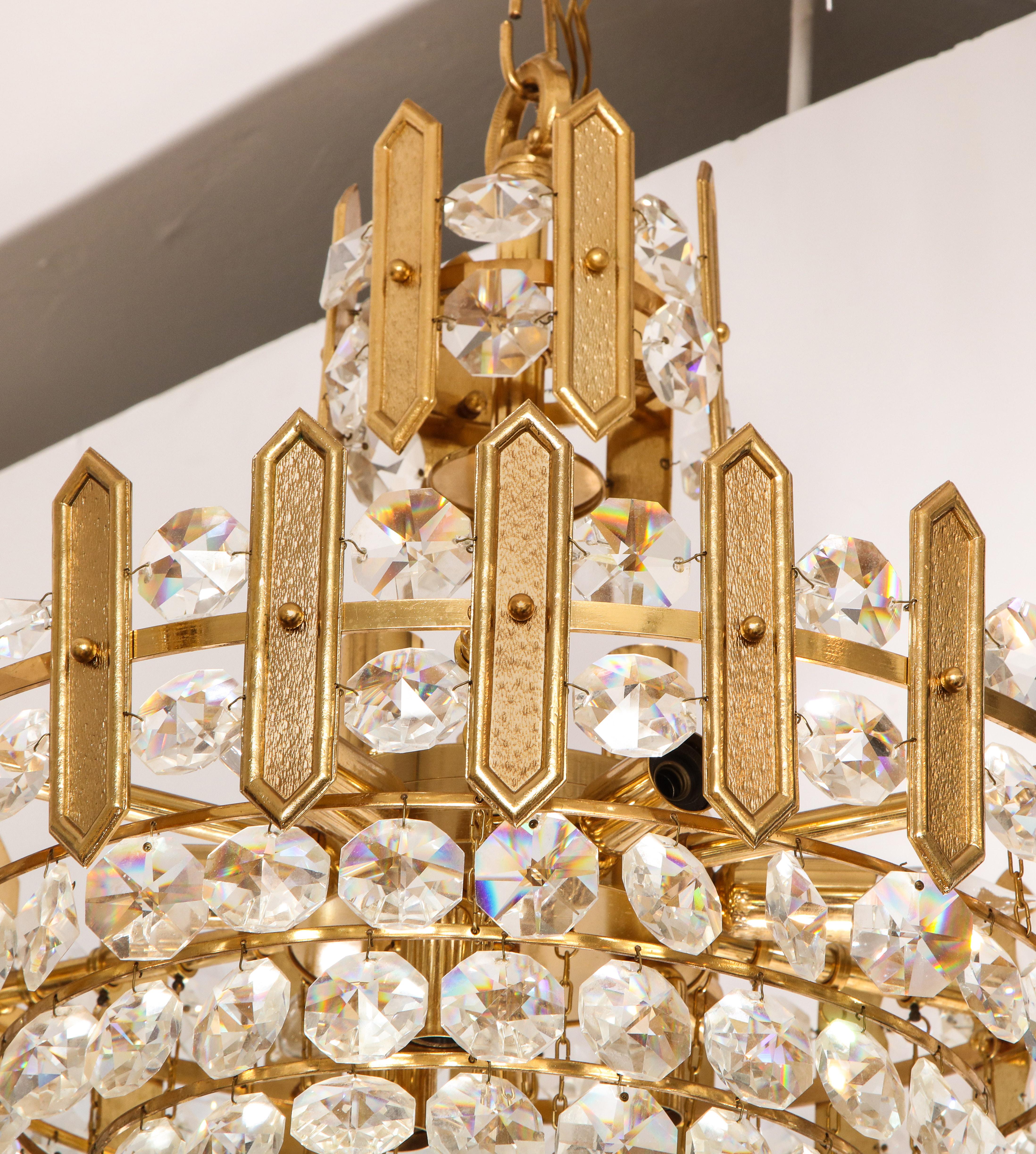 Crystal Embossed brass and crystal tiered chandelier by Palwa For Sale