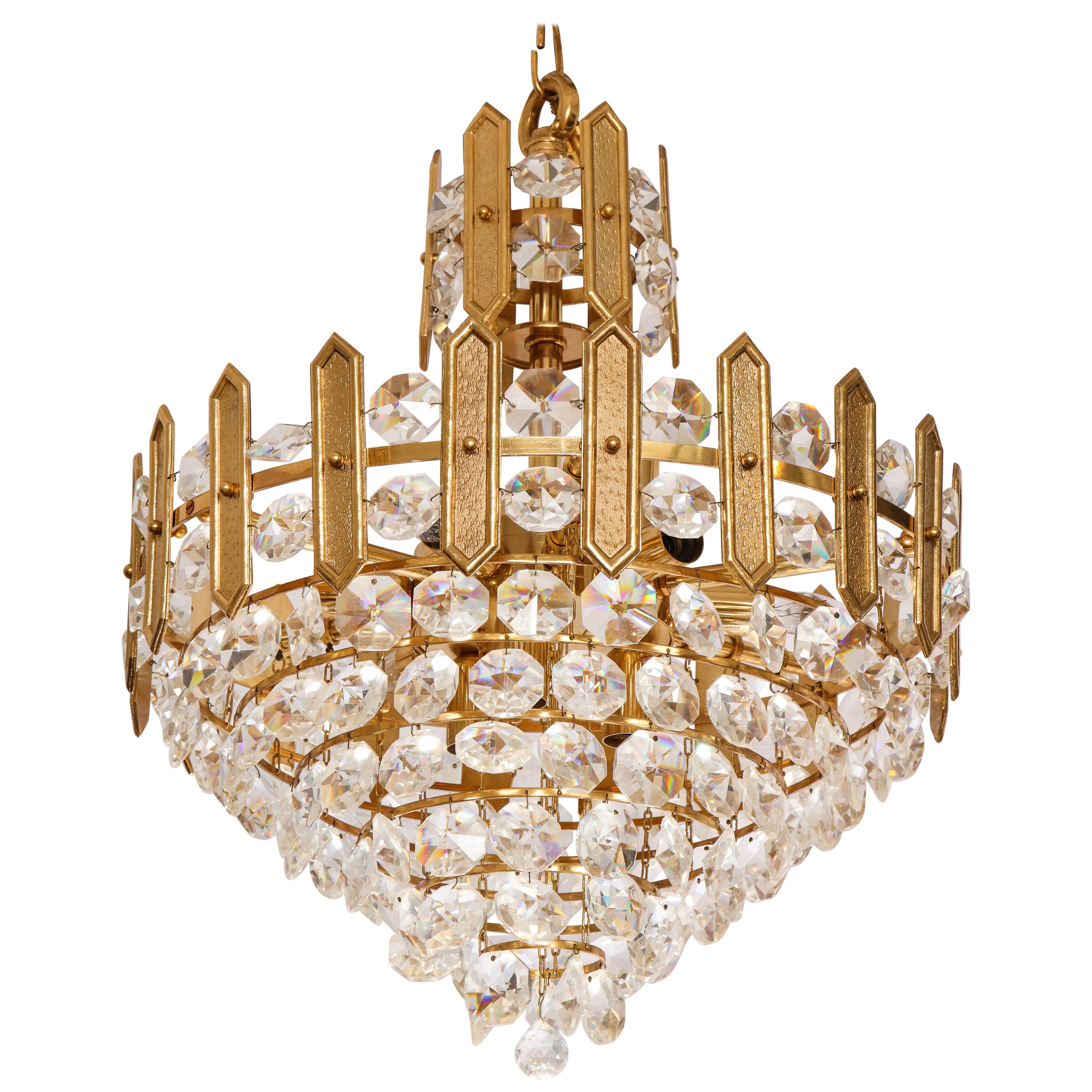 Embossed brass and crystal tiered chandelier by Palwa For Sale