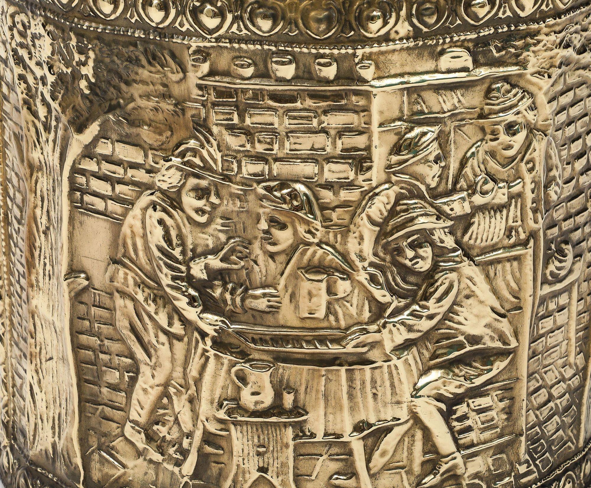 Late 19th Century reposse brass coal or kindling bucket, the front and back embossed with rustic tavern scenes.