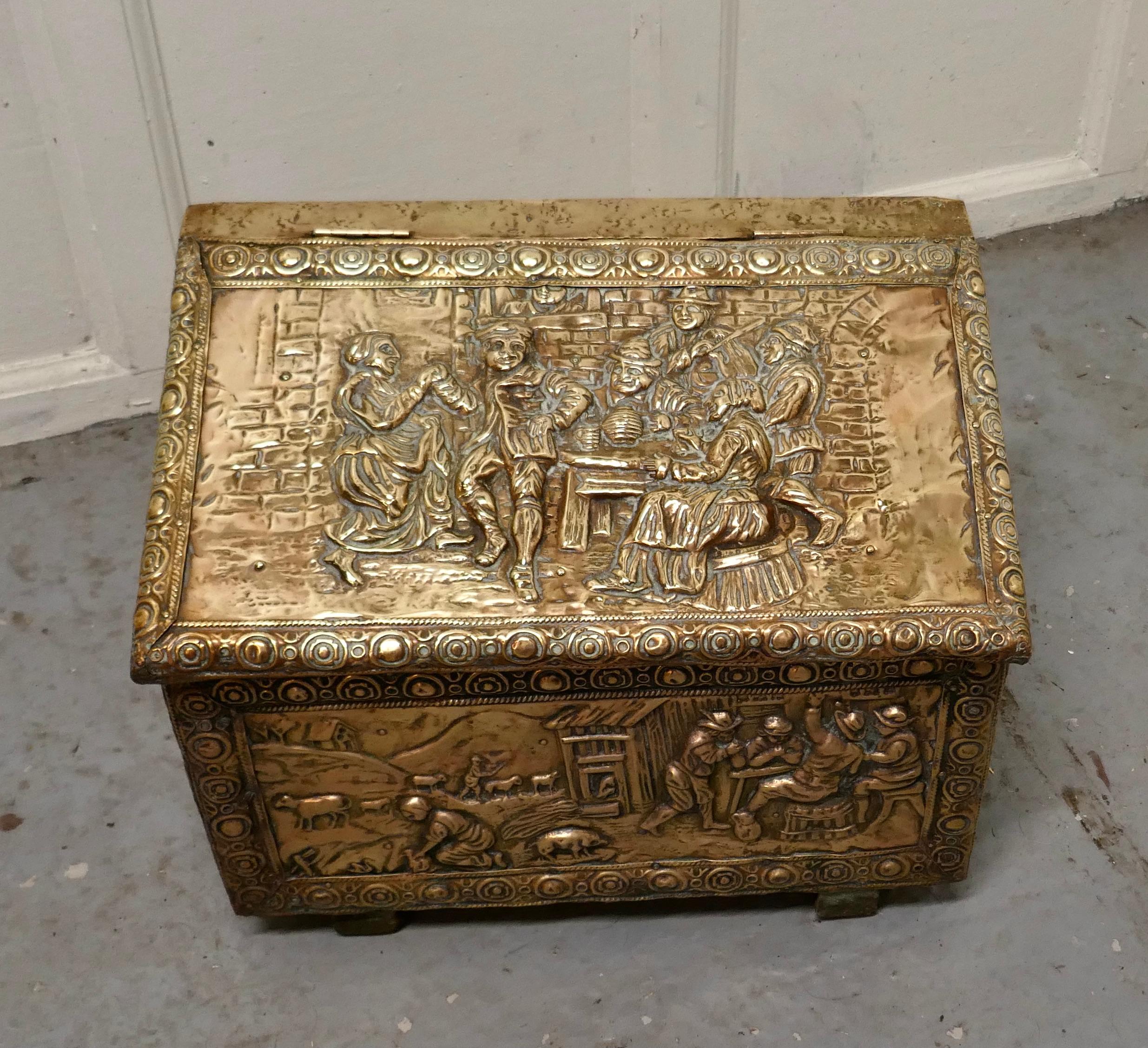 Embossed brass log box, with country scenes 

This is a delightful chest is made in brass with a wooden lining, the beaten brass is embossed with Tavern scenes
This is an old piece it has a very good colour, it is in good condition for its years