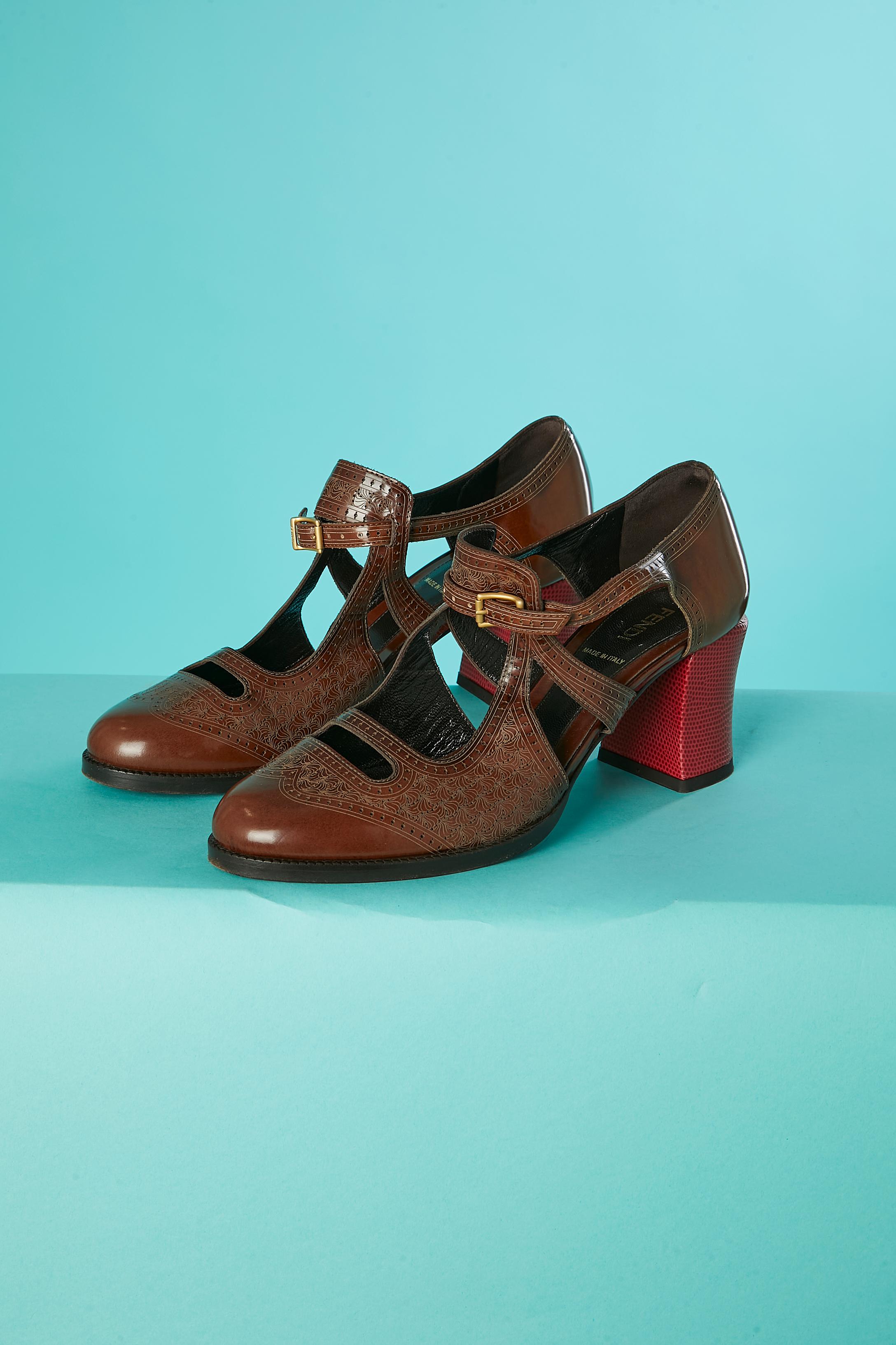 Embossed leather shoe with red heels and buckles. 
Heel 's height = 6,5 cm 
Shoe Size = 6,5 cm 