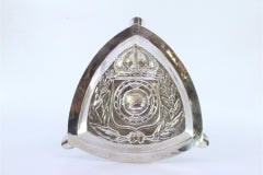 Embossed silver ashtray with floral motifs, armillary sphere, three rests
