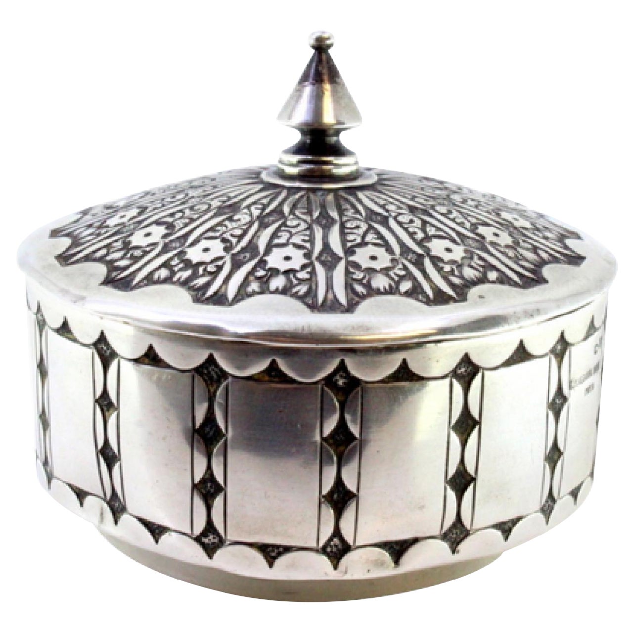 Embossed silver box with a circular shape and a knob on the removable lid