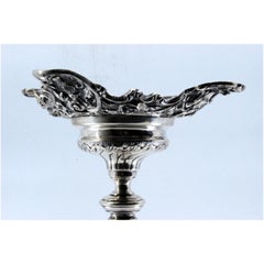 Embossed silver candlestick with square base and cut-out supports