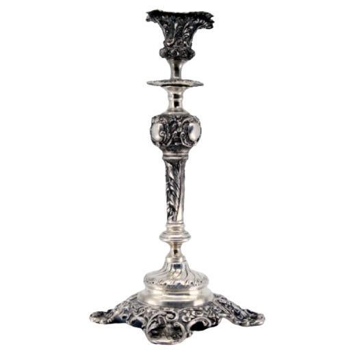 Embossed silver candlestick with square base and cut-out supports