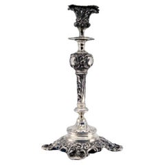 Embossed silver candlestick with square base and cut-out supports
