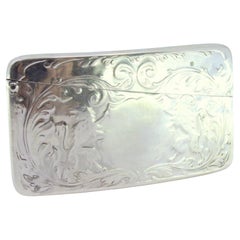 Embossed silver card case with coat of arms between lions