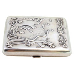 Embossed silver case in Art Nouveau style with gold interior, spring lid