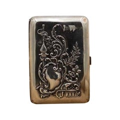 Embossed silver case with Islamic motifs, monogram plate, floral bouquets