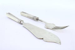 Embossed silver cheese knife and fork