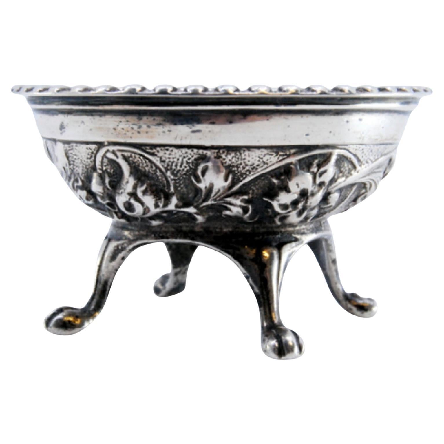 Embossed silver compote with pearled rim on four claw-shaped feet