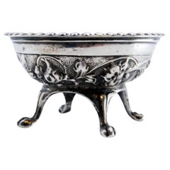 Embossed silver compote with pearled rim on four claw-shaped feet
