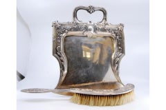 Embossed silver crumb set w/ floral motifs around monogram