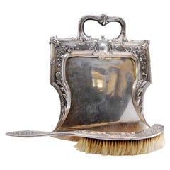 Embossed silver crumb set w/ floral motifs around monogram