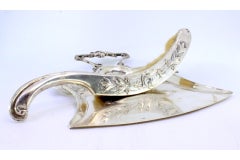 Embossed silver crumb set w/ warrior, garlands, flowers & fruit