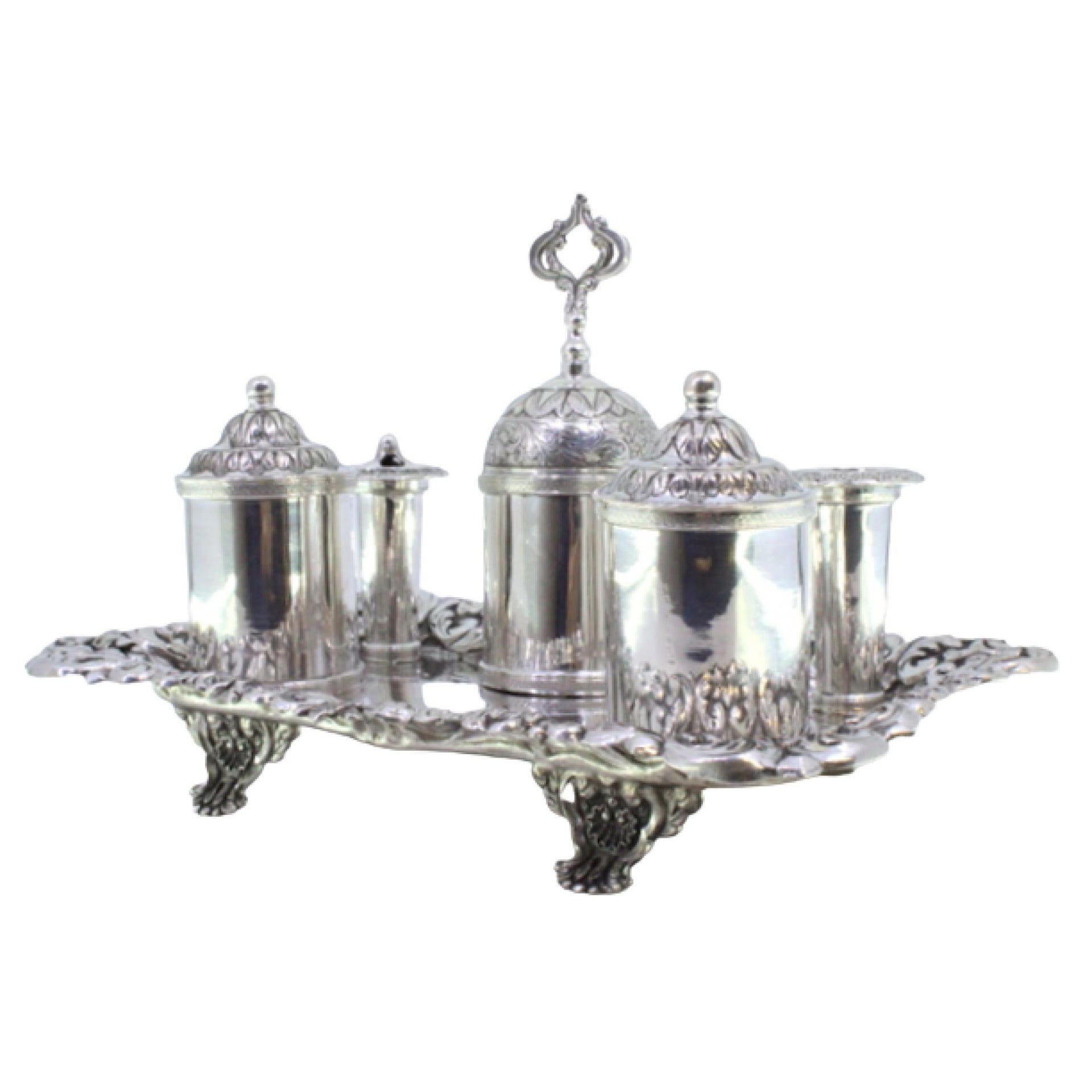 Embossed silver inkwell with reservoirs, bell 
claw-shaped feet