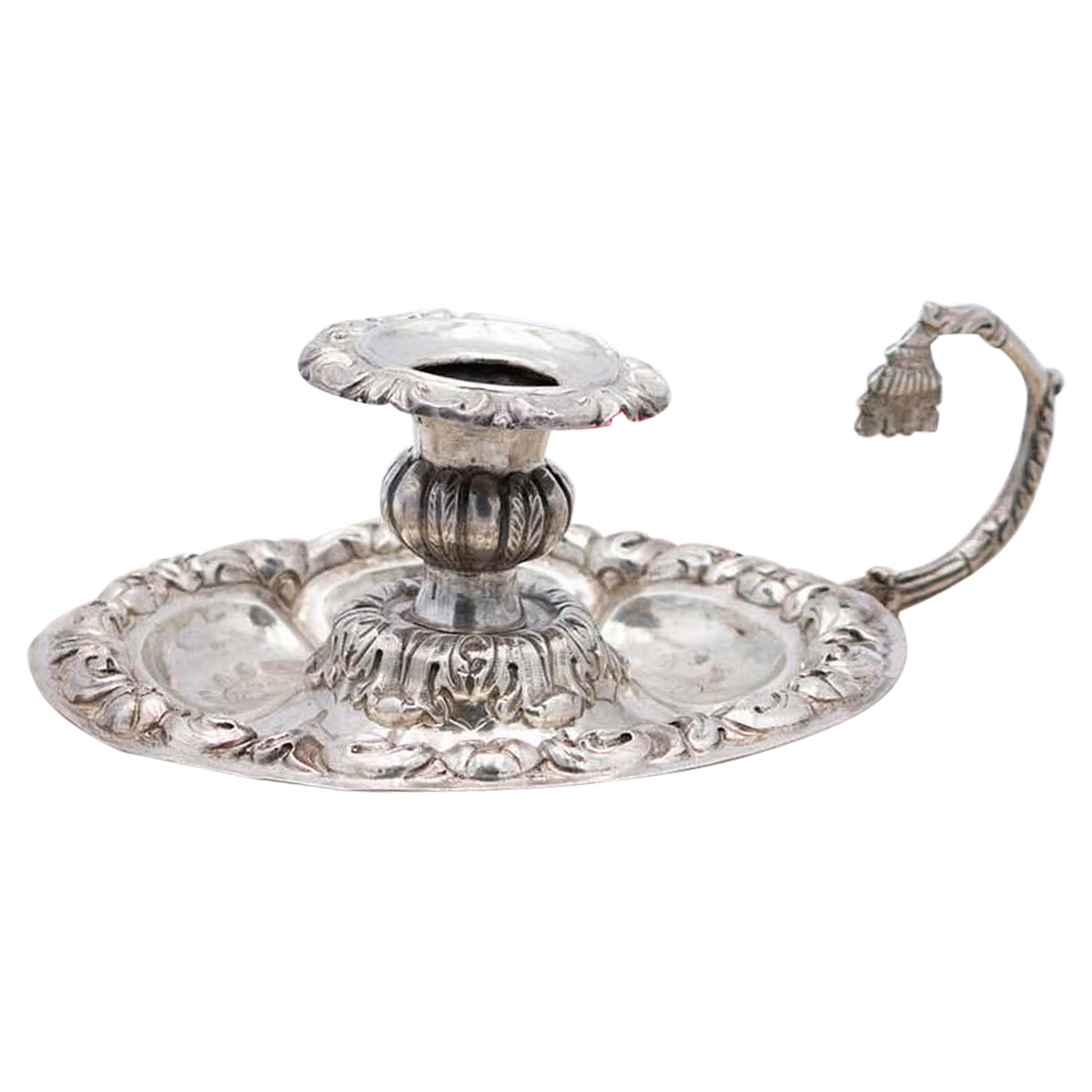 Embossed silver paddle with circular base and open handle