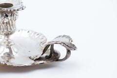 Embossed silver paddle with floral motifs