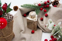 Embossed silver perfume bottle with young ladies in everyday scenes