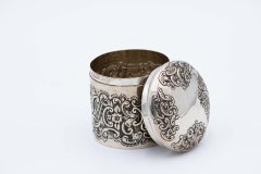 Embossed silver pot with cylindrical scrolls and garlands