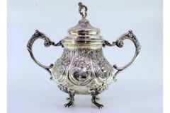 Embossed silver sugar bowl w/ floral motifs, acanthus leaves & 4 claw feet