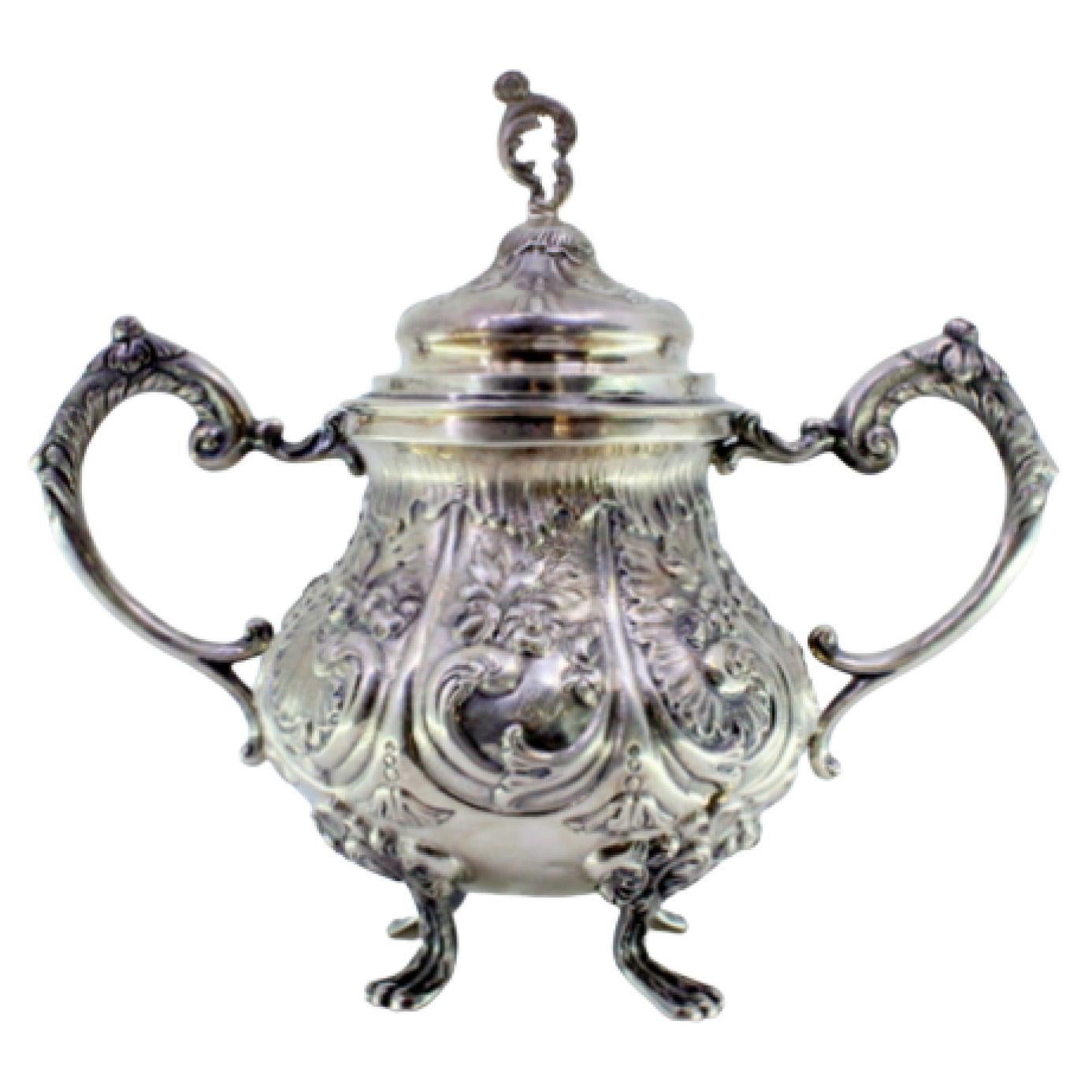 Embossed silver sugar bowl w/ floral motifs, acanthus leaves 
4 claw feet