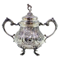 Embossed silver sugar bowl w/ floral motifs, acanthus leaves 
4 claw feet
