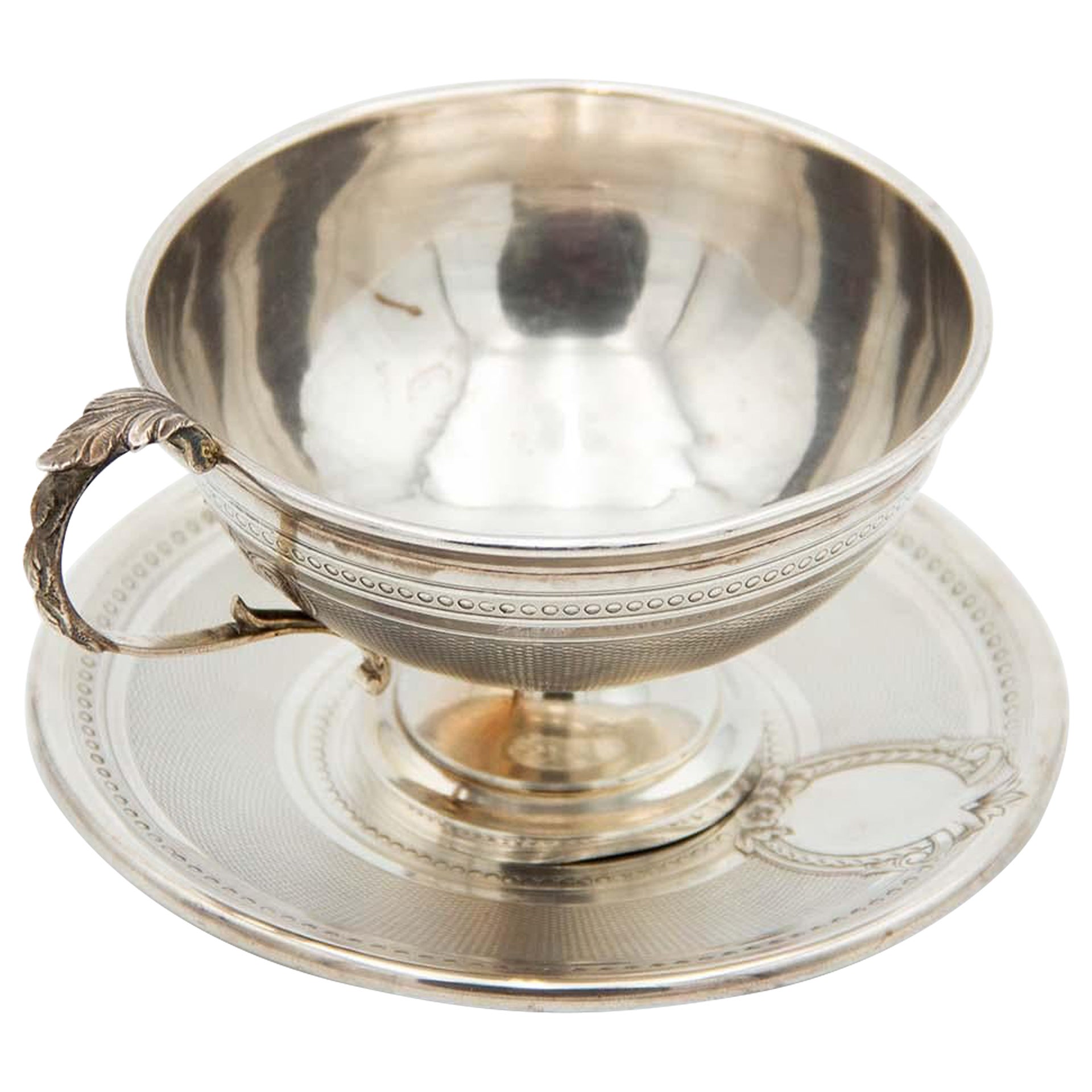 Embossed teacup with guilloche silver saucer, pearl trim and embossed handle