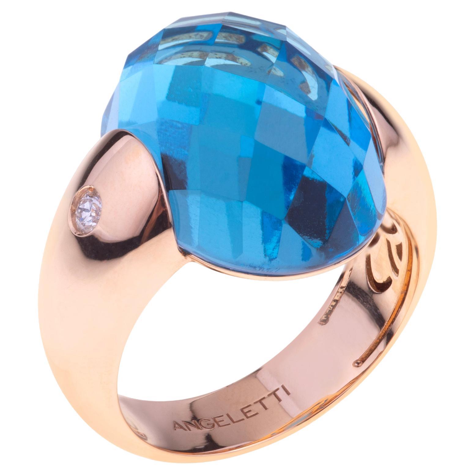 Collection Embrace d'Angeletti. Bague en or rose avec topaze bleue et diamants